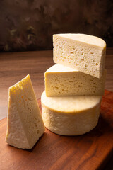 Semi-cured cheese, a wonderful semi-cured cheese from Minas Gerais on a rustic surface, selective focus.
