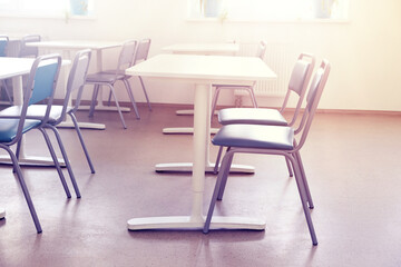 School classroom with chairs and desks on sunny day