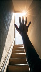 Aspiring hand reaching toward bright window light indoor staircase symbol of hope uplifting environment low angle view