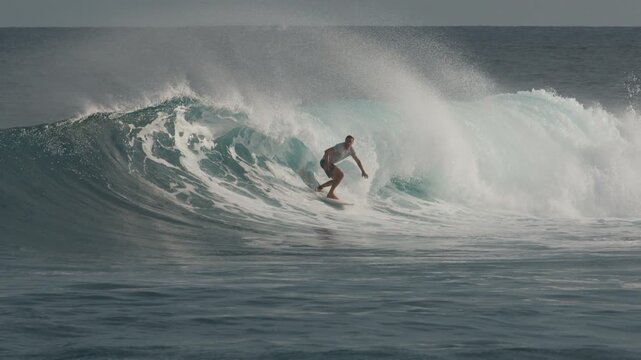 Surfer rides the big wave in the Maldives
