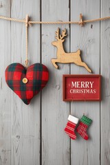 A Christmas holiday arrangement featuring a red plaid heart pillow, a small wooden reindeer cutout, a framed "MERRY CHRISTMAS" sign, and three miniature hanging stockings, all set against a rustic whi