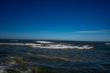 Powerful Ocean Waves Under Clear Blue Sky