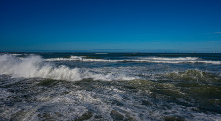 Powerful Ocean Waves Under Clear Blue Sky