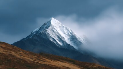 Mountain covered in snow and clouds