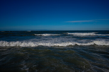 Powerful Ocean Waves Under Clear Blue Sky