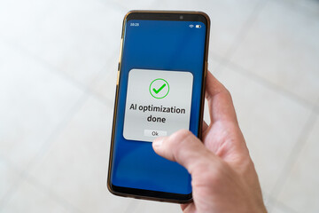 AI optimization done message on smartphone. Concept of working with artificial intelligence.