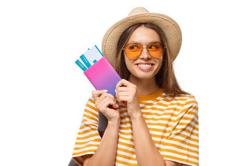 Summer shot of smiling dreamy young female traveller holding passport with flight tickets