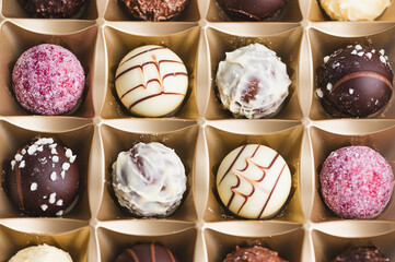 Box of assorted chocolate truffles in neat arrangement