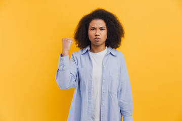 African American woman feeling angry and showing fist