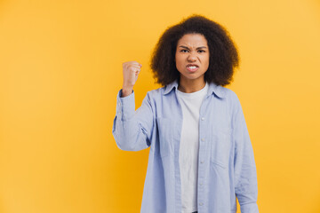 African American woman feeling angry protesting with raised fist