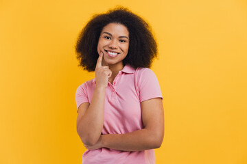 African American woman thinking, smiling with hand on cheek