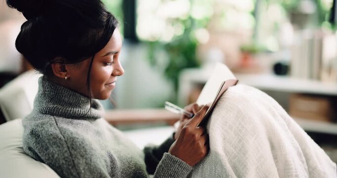 Diary, thinking and writing with woman on sofa in living room of home for reflection or memories. Journaling, notebook and pen with thoughtful person in apartment for personal growth or planning