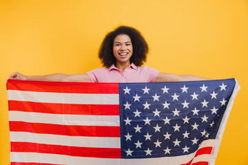 African American woman proudly holding American flag