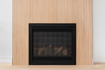 Obraz premium A modern fireplace with white oak wood slats, white oak flooring, and a black electric fireplace.