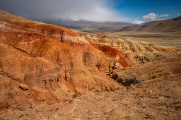 Panoramic view of red and yellow mountains with canyons and gorges at Mars Altai Russia. Popular tourist destination showcasing unique colorful geological formations.