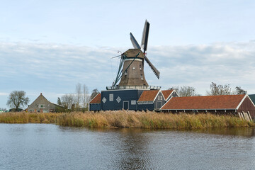 View of the De Rat sawmill in autumn. De Rat is an octagonal smock mill in IJlst Friesland The Netherlands and was built in 1828. De Rat is one of three sawmills in Friesland. Image with copy space.	