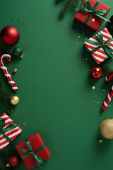 Vibrant vertical festive scene featuring wrapped gifts, candy canes and ornaments arranged along a...