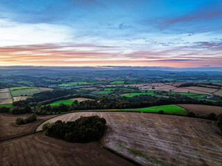 Obraz premium Colours of Sunset over Devon Farms and Fields, Berry Pomeroy from a drone, Totnes, England