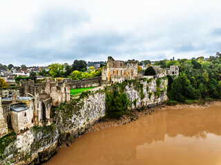 Fototapeta premium Autumn over Chepstow Castle and River Wye from a drone, Chepstow, Monmouthshire, Wales, UK