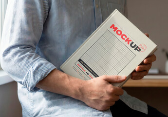 Man Holding Hard Cover Book Mockup