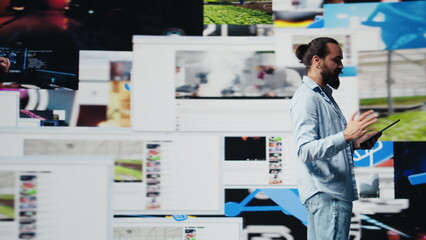 With a hands free microphone, male trend setter hosts a live presentation offering insight for...