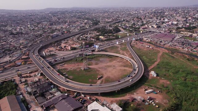 Aerial shot of N1 Highway Interchange cutting through beautiful dense urban Accra landscape