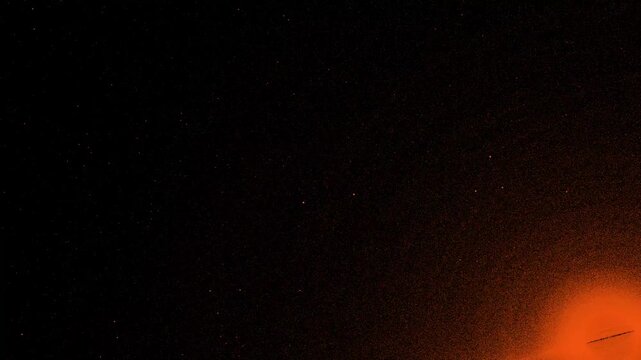 Futuristic digital orange particles flowing along an abstract cyber grid, fast 4K loop on dark background for technology and sci-fi videos.