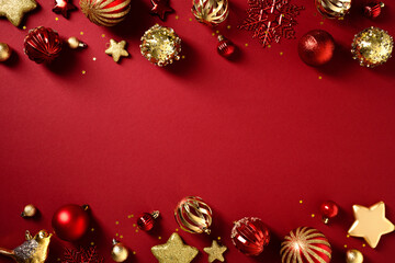 Christmas flat lay composition with red and gold ornaments creating a double borde