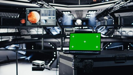 Mockup notebook used for orbital navigation data in cockpit during red planet journey. Green screen laptop used for operating spacecraft control interface next to monitor displaying Mars dashboard
