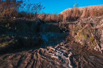 turbulent stream of dirty water in the hills