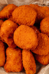 A close-up of crispy golden nuggets highlights their crunchy texture and savory appeal.