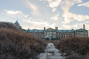 An abandoned institutional building with extensive grounds.