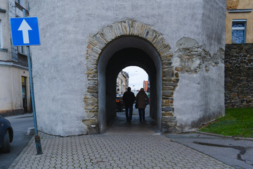 man and woman in passage under the old tower