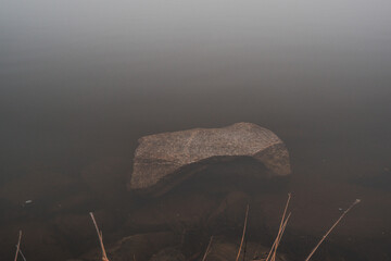stone by the lake in the mist © konrad hryciuk