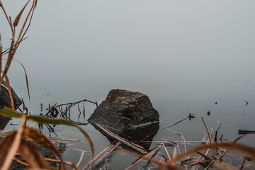 stone by the lake in the mist