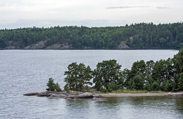 A beautiful landscape of the wide Scandinavian water area with rocky islands. A summer day on the Baltic Sea bay near Stockholm, Sweden.
