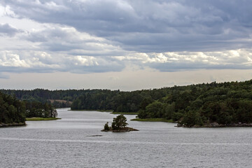 A beautiful landscape of the wide Scandinavian water area with rocky islands. A summer day on the Baltic Sea bay near Stockholm, Sweden.