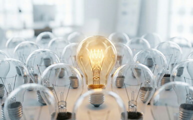 A single glowing light bulb shines brightly amidst many unlit ones, symbolizing a brilliant idea, innovation, and leadership.