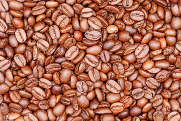 Roasted coffee beans creating natural brown texture background