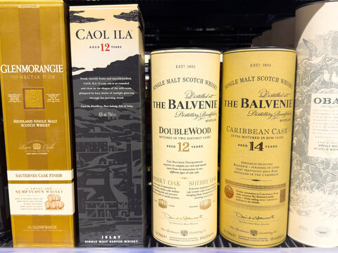 Villach, Austria - December 10, 2025: Collection of premium Scotch whisky bottles including Glenmorangie, Caol Ila, and The Balvenie showcasing elegant packaging and rich heritage