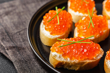 Fresh baguette canapes with red caviar and cream cheese
