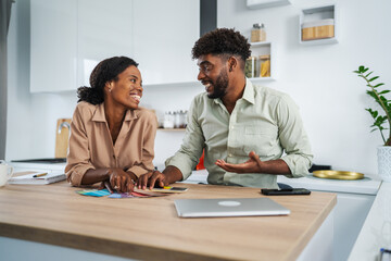 African american couple choosing paint colors for home renovation