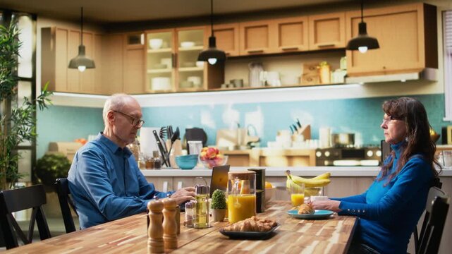 Senior old man trying to catch attention of absent zoned out wife, detached woman being defocused and dissociated from her husband over morning coffee. Disconnected aged partner. Camera A.