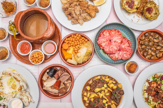 A display of earthenware casseroles and ceramic dishes offering everything from Madrid-style tripe stew to simple yet perfect anchovy-stuffed olives and slices of bread with tomato