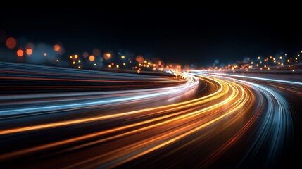 Nighttime city highway with light trails.  Dynamic curves of light streaks, orange and blue hues, against a dark background of city lights.  Abstract representation of speed and movement