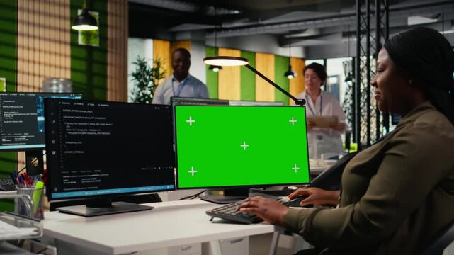 Green screen computer used by admin in office doing software development to launch new features. Mockup PC used by woman in startup company writing computer programs, doing code, camera A