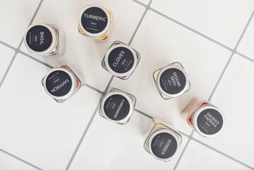 Assorted spices in glass jars with metal lids