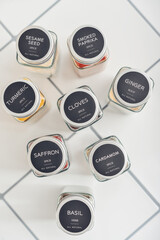 Assorted spices in glass jars with metal lids