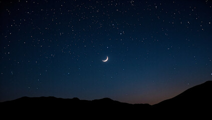 Naklejka premium Crescent moon and stars over a dreamy mountain night sky