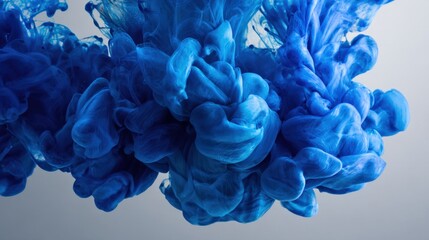 Obraz premium Vibrant Blue Ink Cloud Forming Abstract Shapes in Water, Creating a Mesmerizing Visual Effect